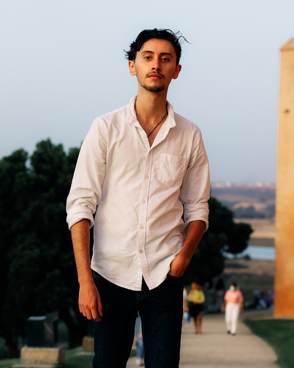 man in white dress shirt standing during daytime