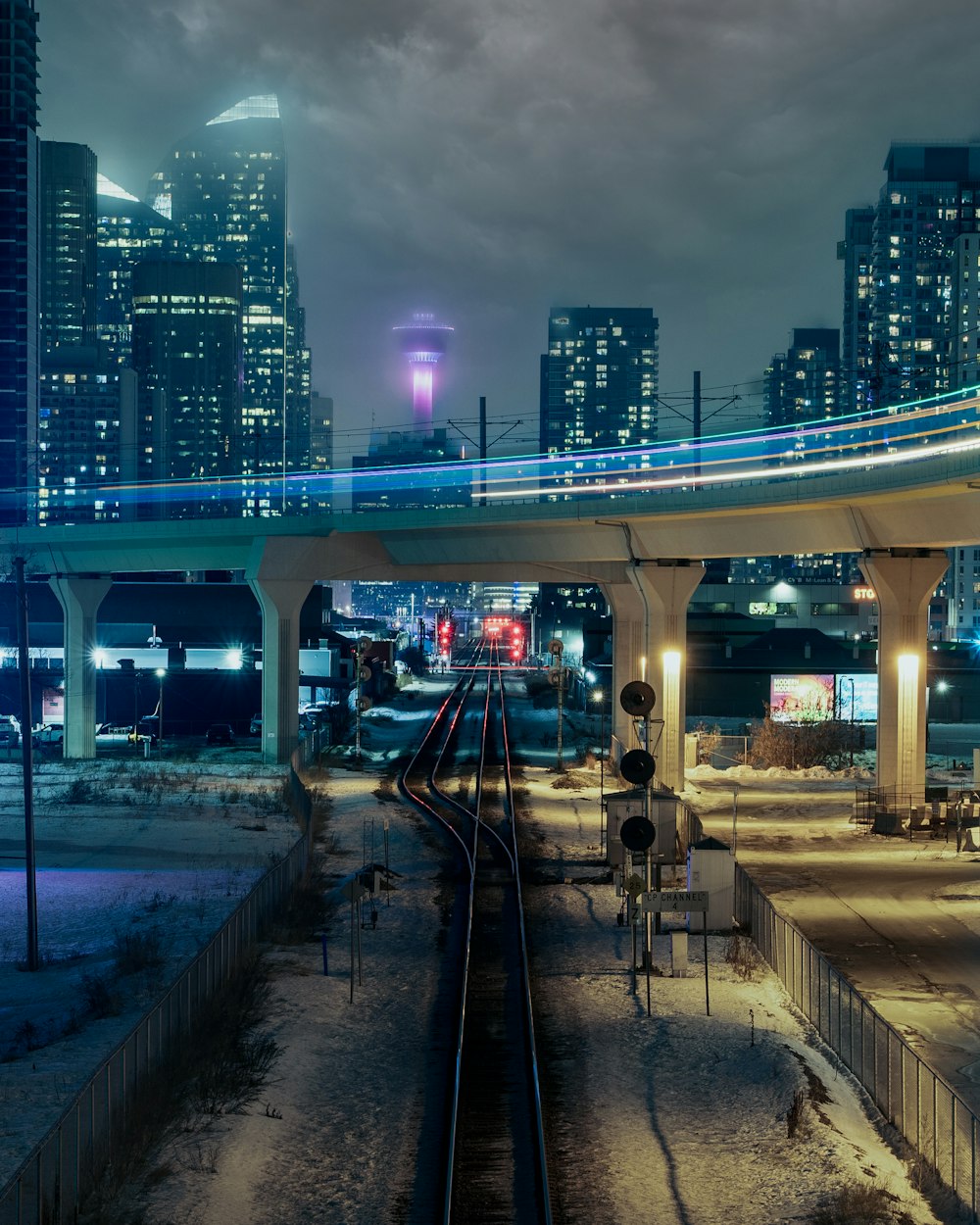 city buildings under gray sky during night time