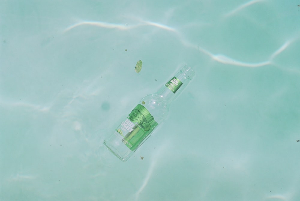 clear glass bottle on green surface