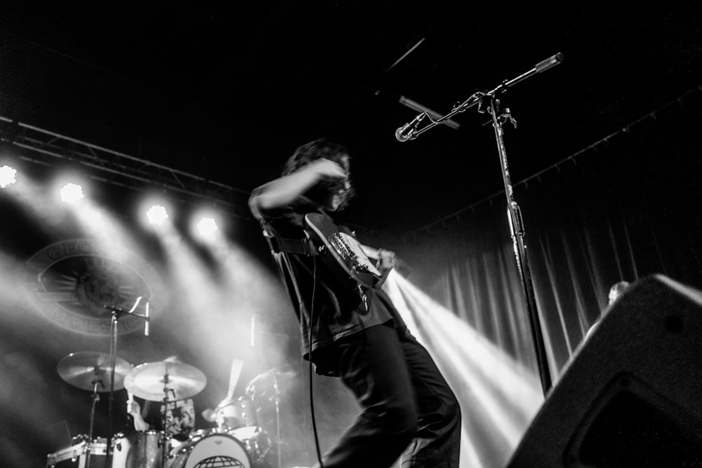 man playing guitar on stage