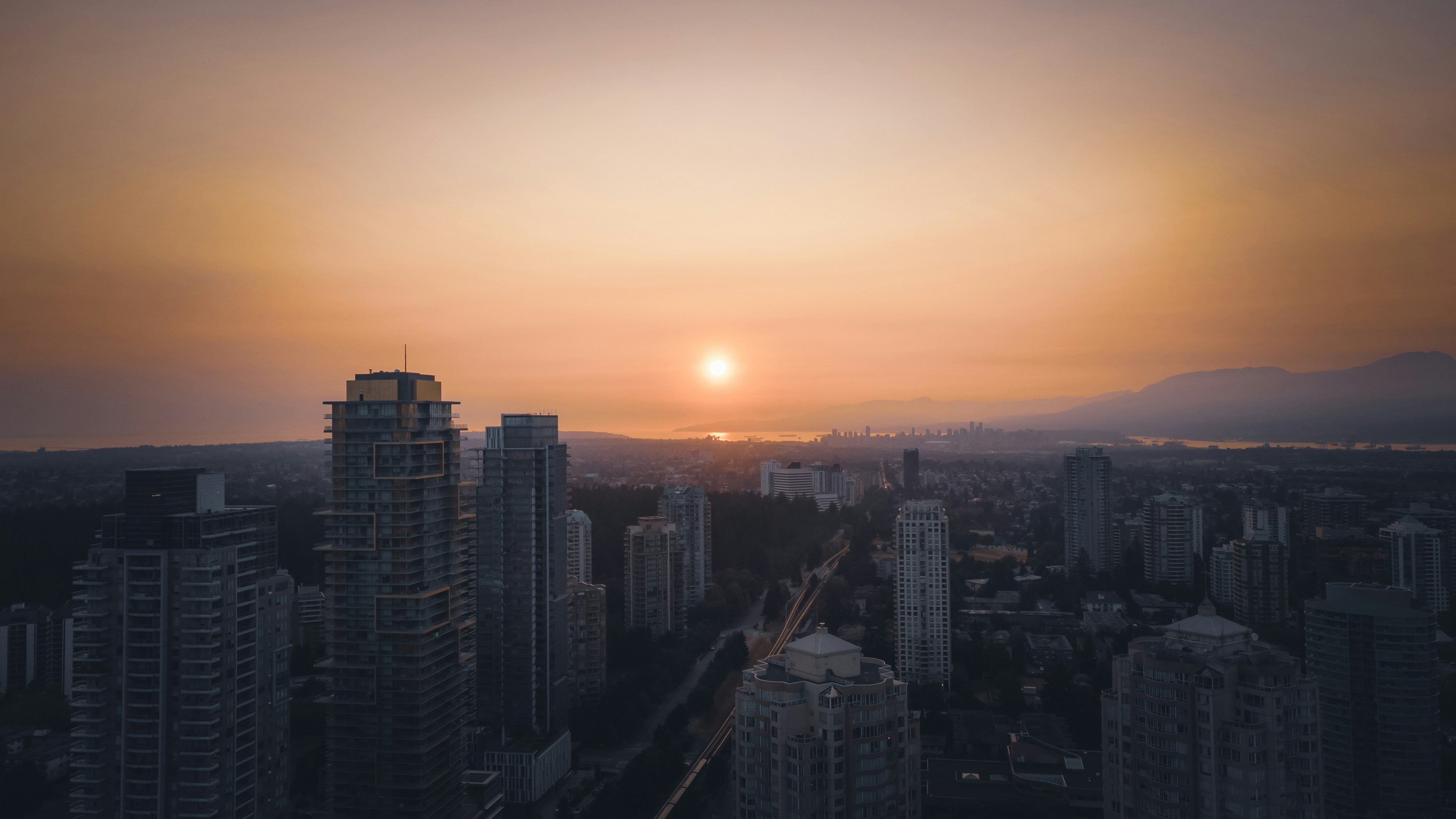 horizonte da cidade durante o pôr do sol com céu alaranjado