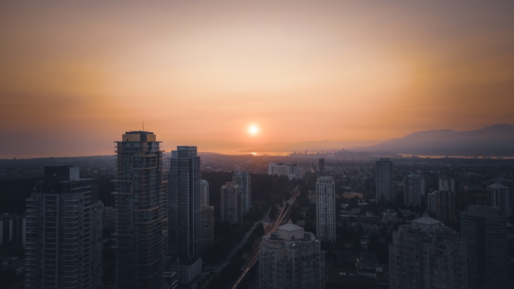 city skyline during sunset with orange sky