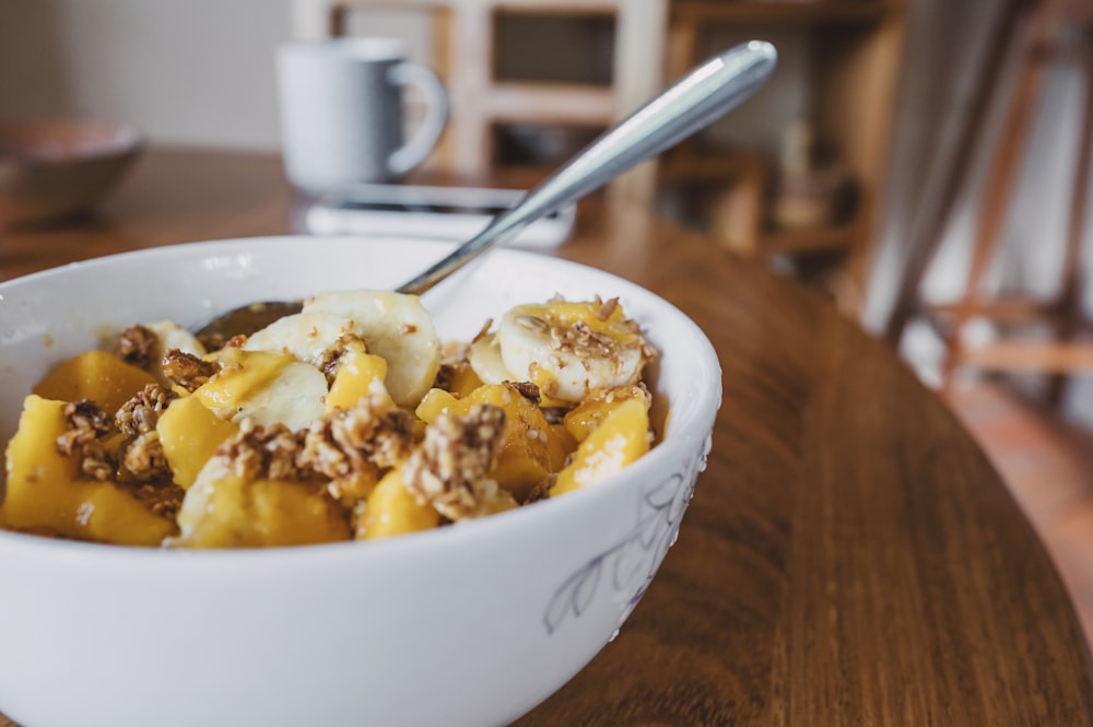 white ceramic bowl with stainless steel spoon