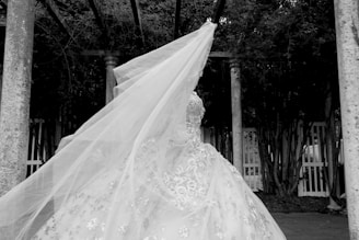 white floral wedding dress on black hanger