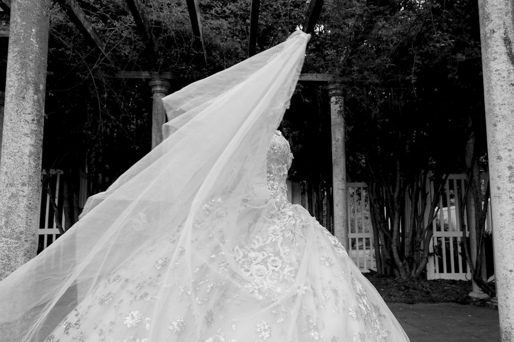 white floral wedding dress on black hanger