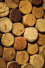 Close-up of natural cork stoppers arranged neatly on a wooden surface.