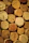 Close-up of a weathered wood wall adorned with handcrafted wine cork art featuring aged copper accents.