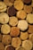 Close-up of natural cork stoppers arranged neatly on a wooden table.