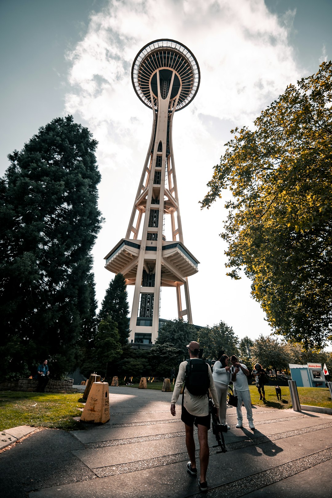 people walking on sidewalk near brown wooden building during daytime