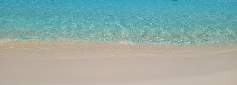 Turquoise waves gently lapping the sandy shores of Antalya's pristine beach.
