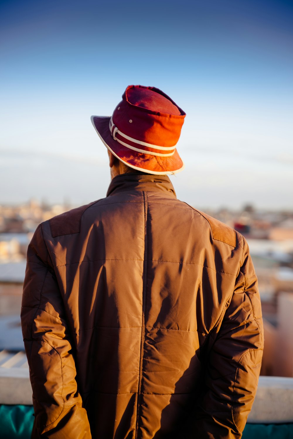 man in brown leather jacket and brown hat