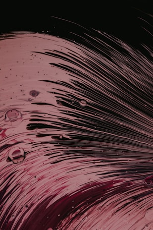 Close-up of vibrant acrylic emulsion being poured into a mixing container, highlighting its smooth texture.