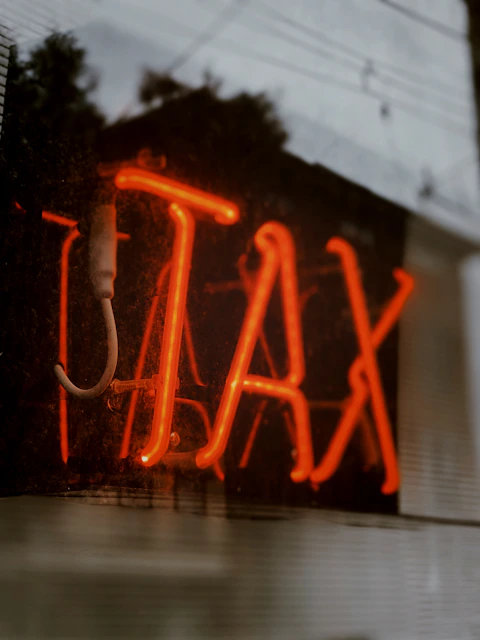 red love neon light signage that says "tax"