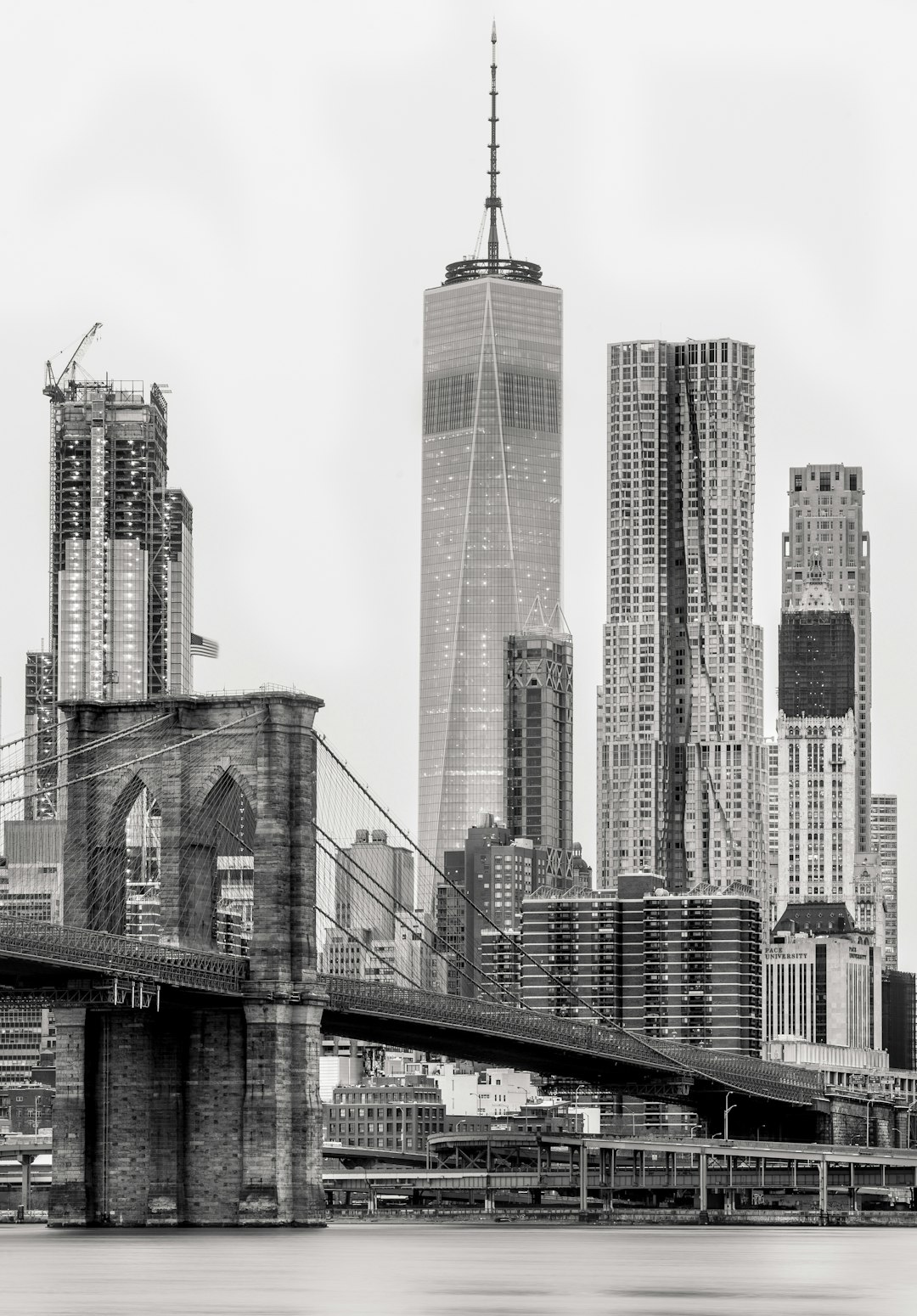 gray concrete bridge near city buildings during daytime