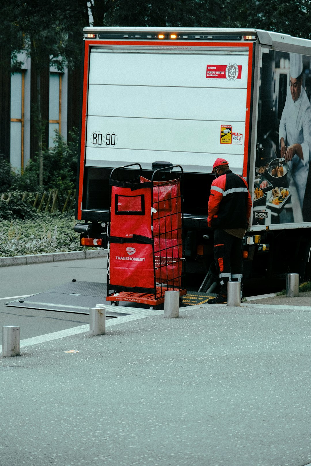 2 men standing on red steel container