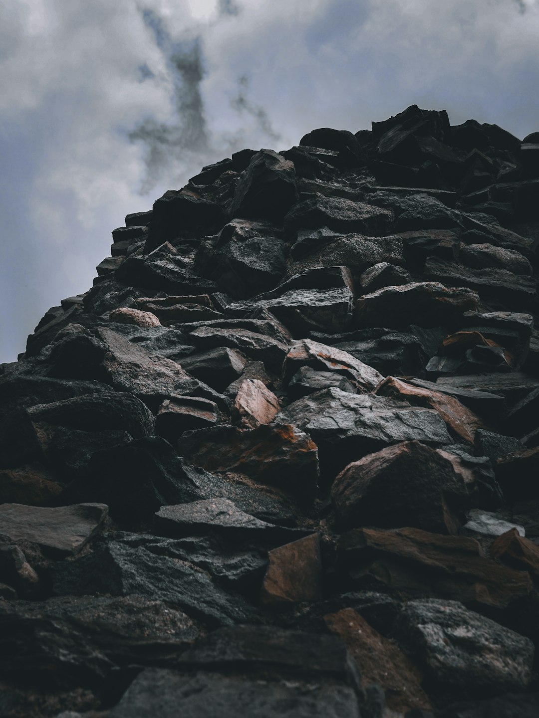 gray rocky mountain under white cloudy sky during daytime