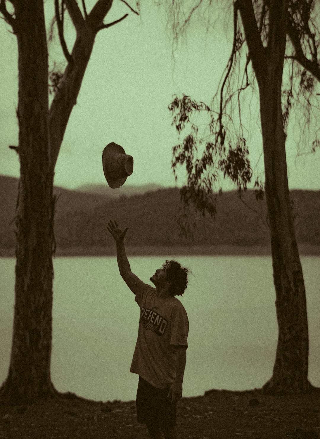 man in white t-shirt holding ball