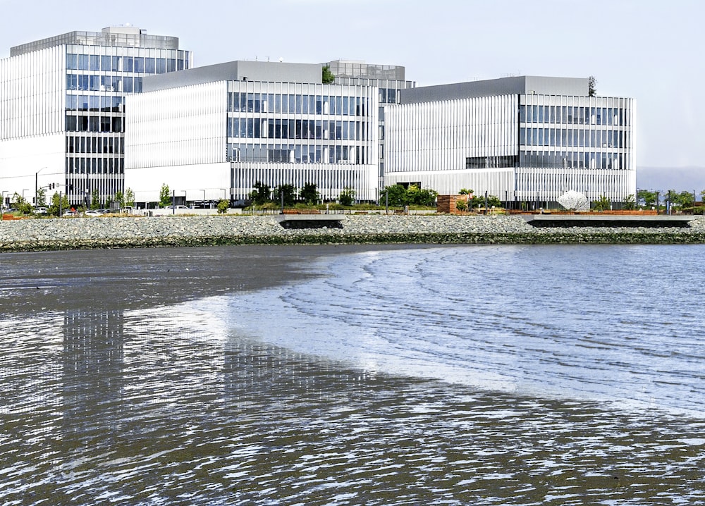 white concrete building near body of water during daytime