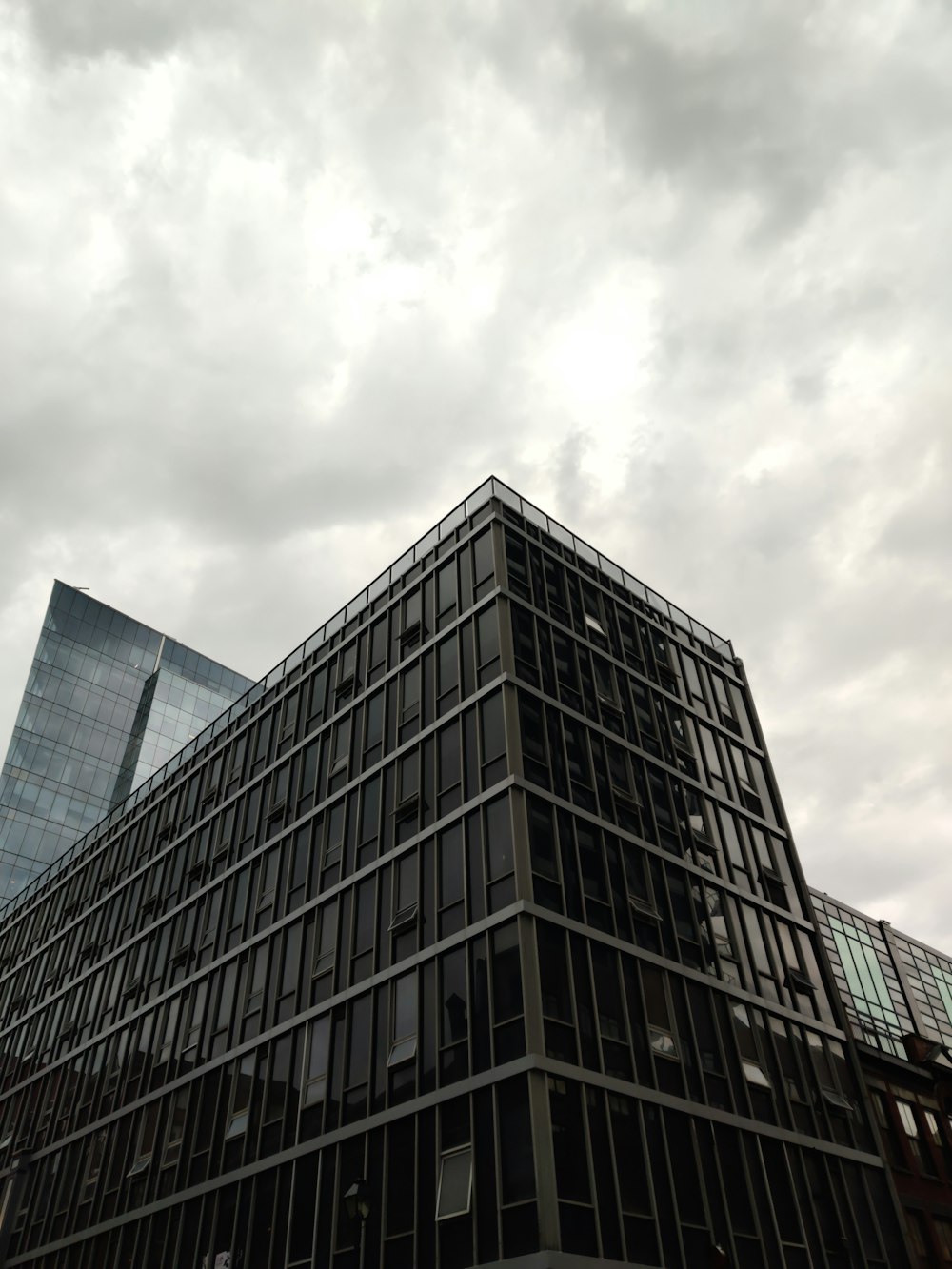 gray concrete building under white clouds during daytime