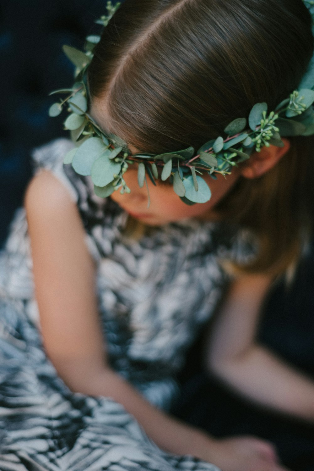 girl in white and black sleeveless dress with blue flower headband