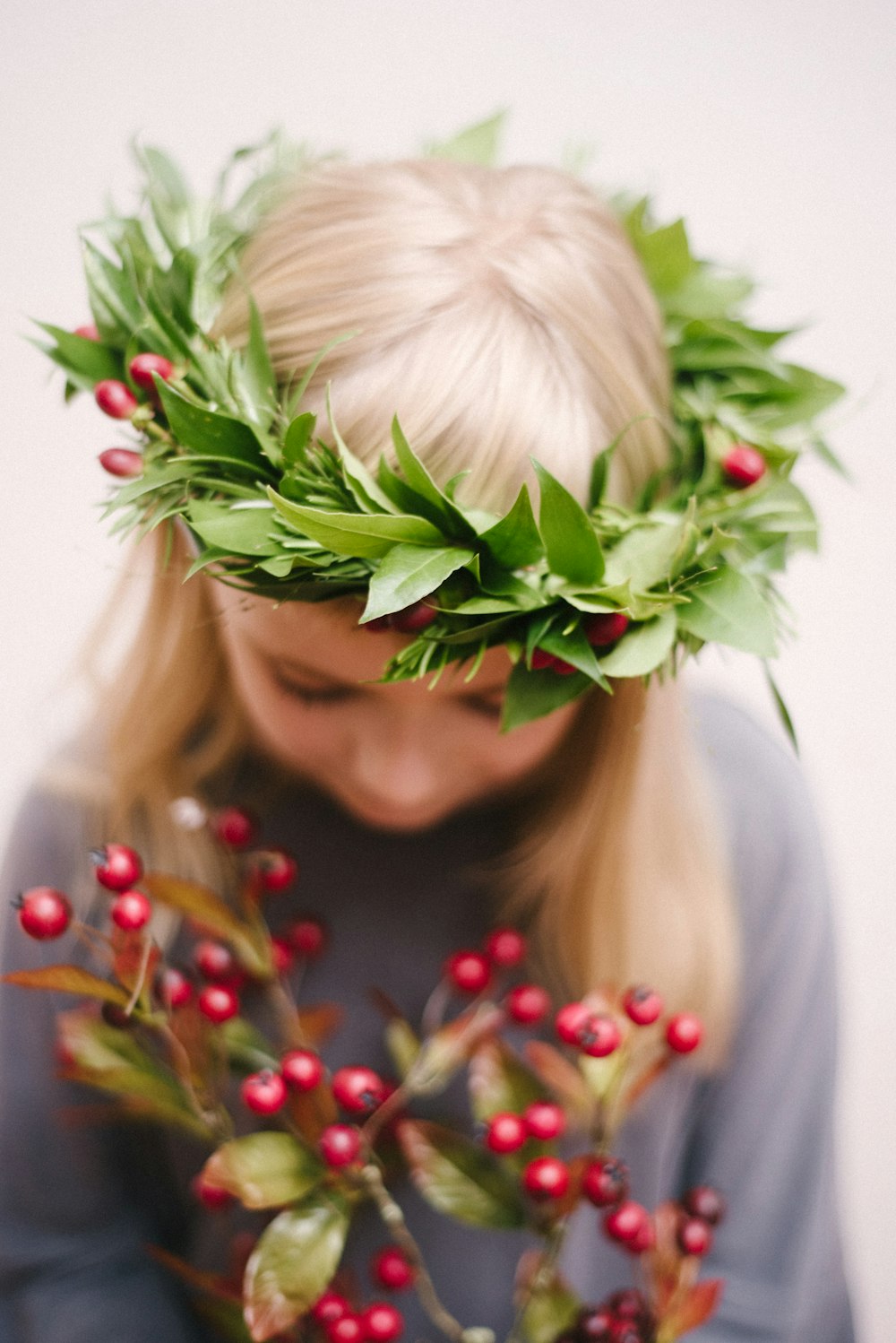 woman in white hair with green leaves on her head