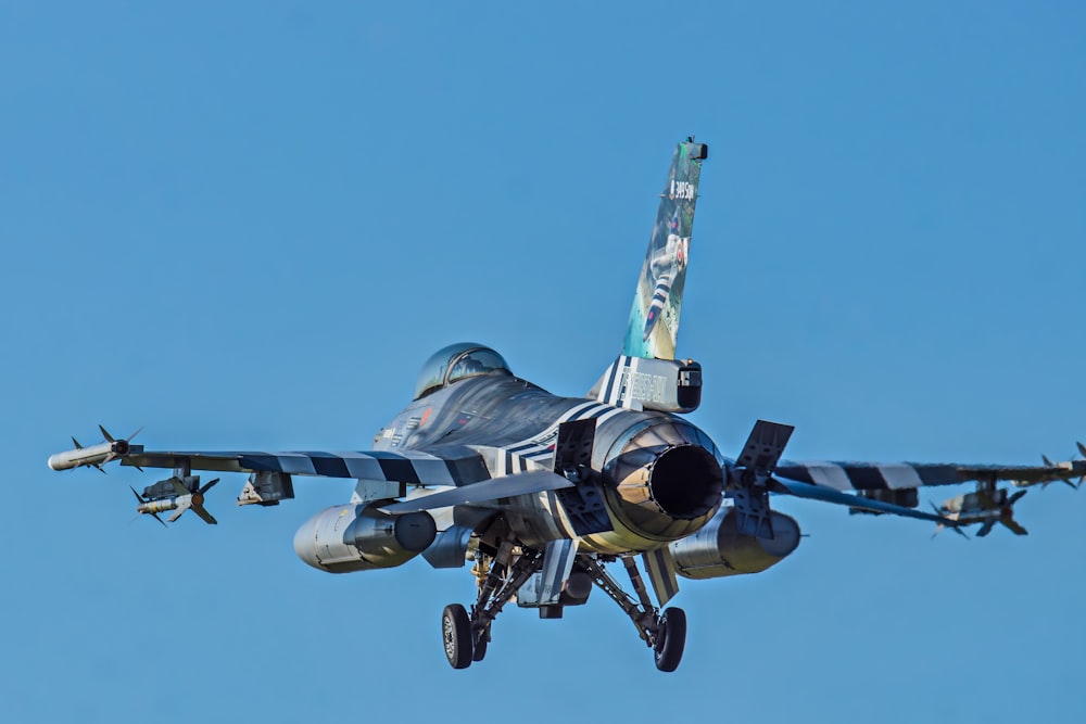 black and yellow jet plane in mid air during daytime