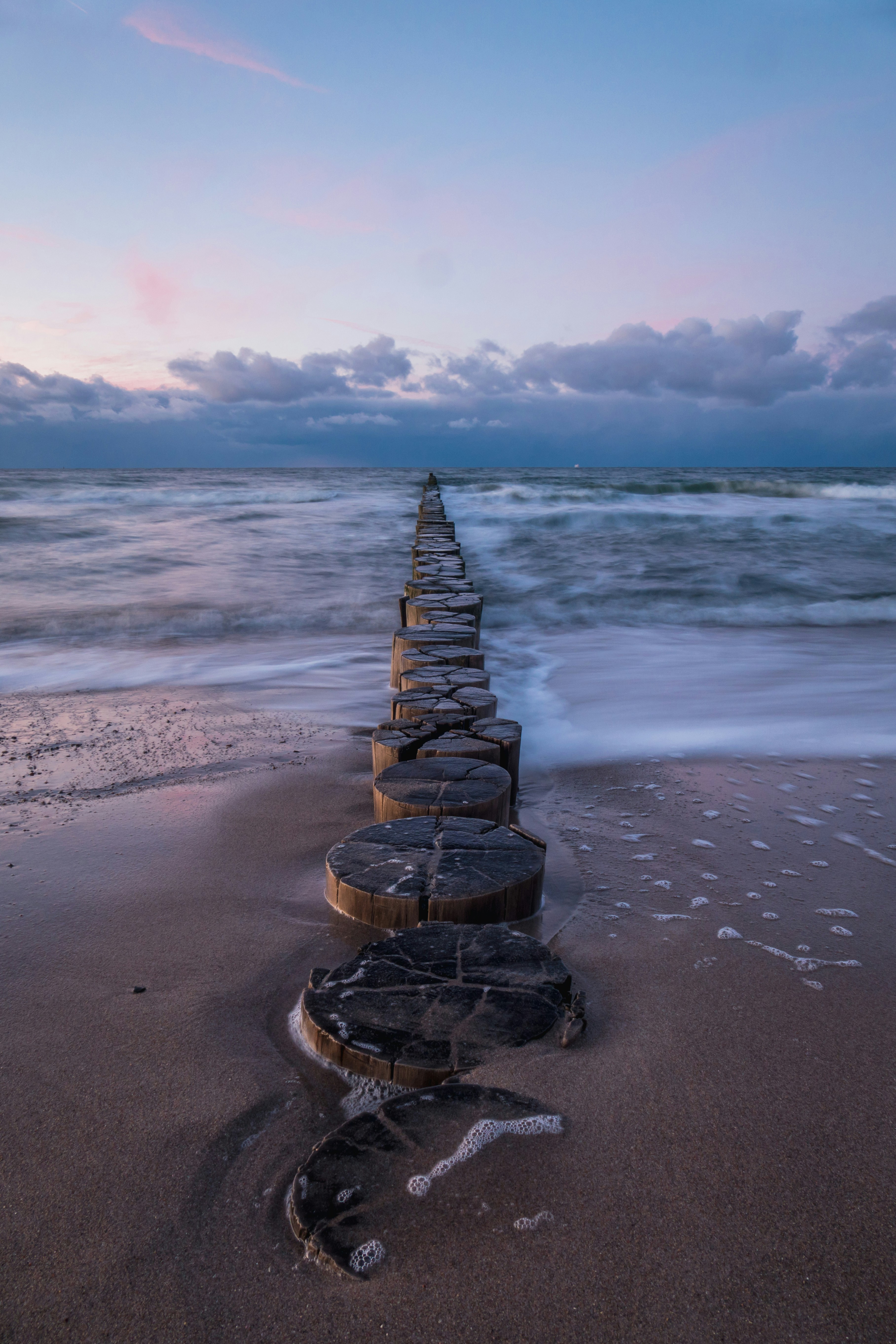 brown wooden dock on beach during daytime