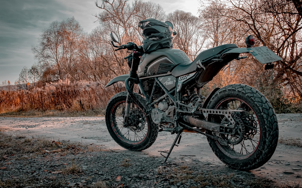 black and brown naked motorcycle parked on brown field during daytime