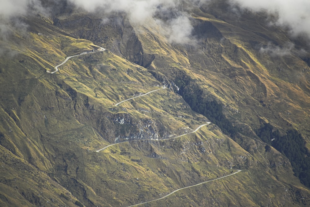 green and gray mountain under white clouds during daytime