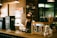 A barista preparing a cup of tea using instant tea premix in a cozy café setting.