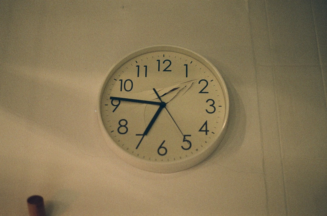 white analog wall clock at 10 00