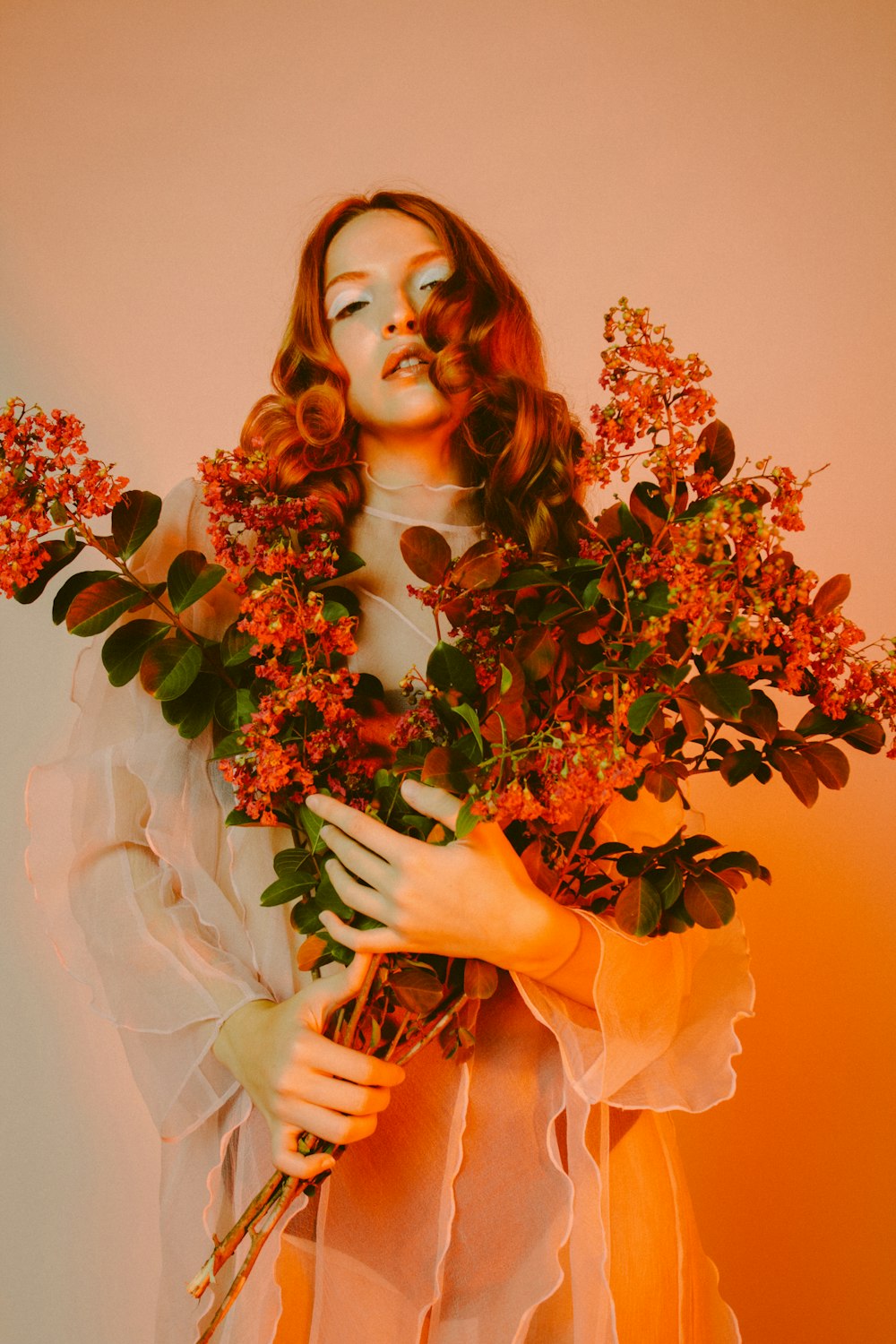 woman in white wedding dress holding bouquet of flowers