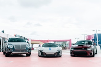white and black cars on parking lot during daytime
