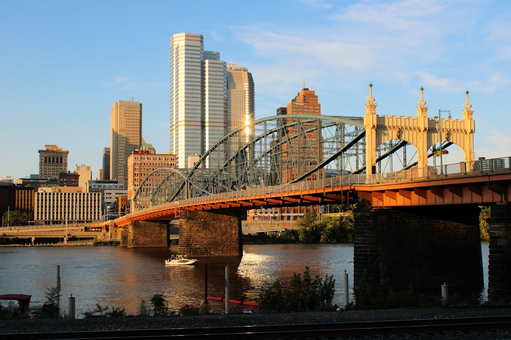 bridge over water near high rise buildings during daytime