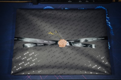 A neatly packaged box of vibrant 2x2 inch photo magnets ready to ship.