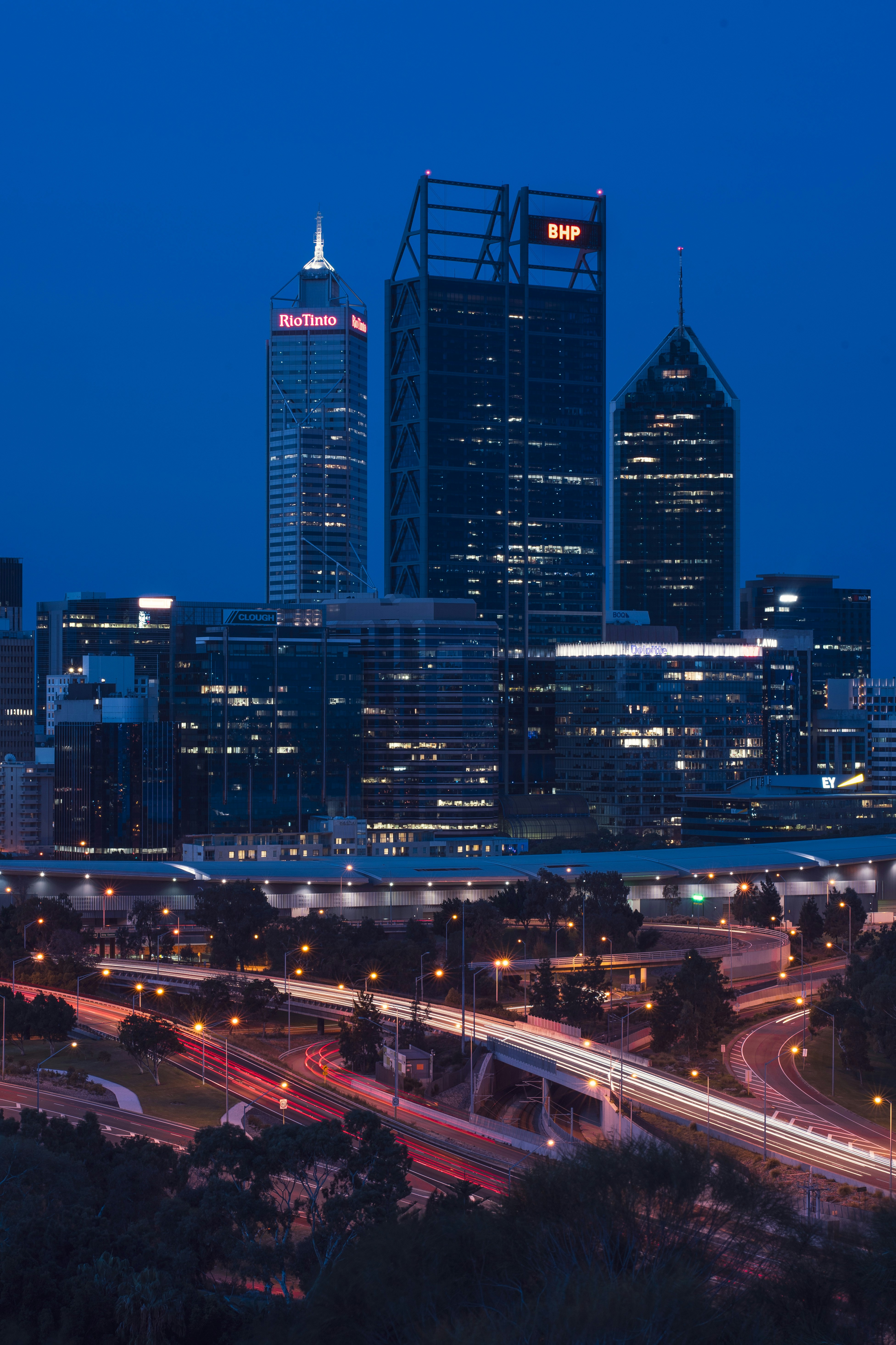 a city skyline at night with a lot of traffic