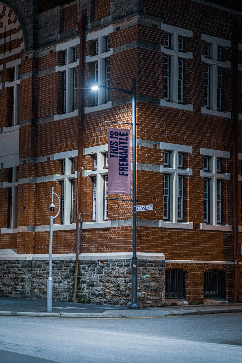 a brick building with a street sign in front of it