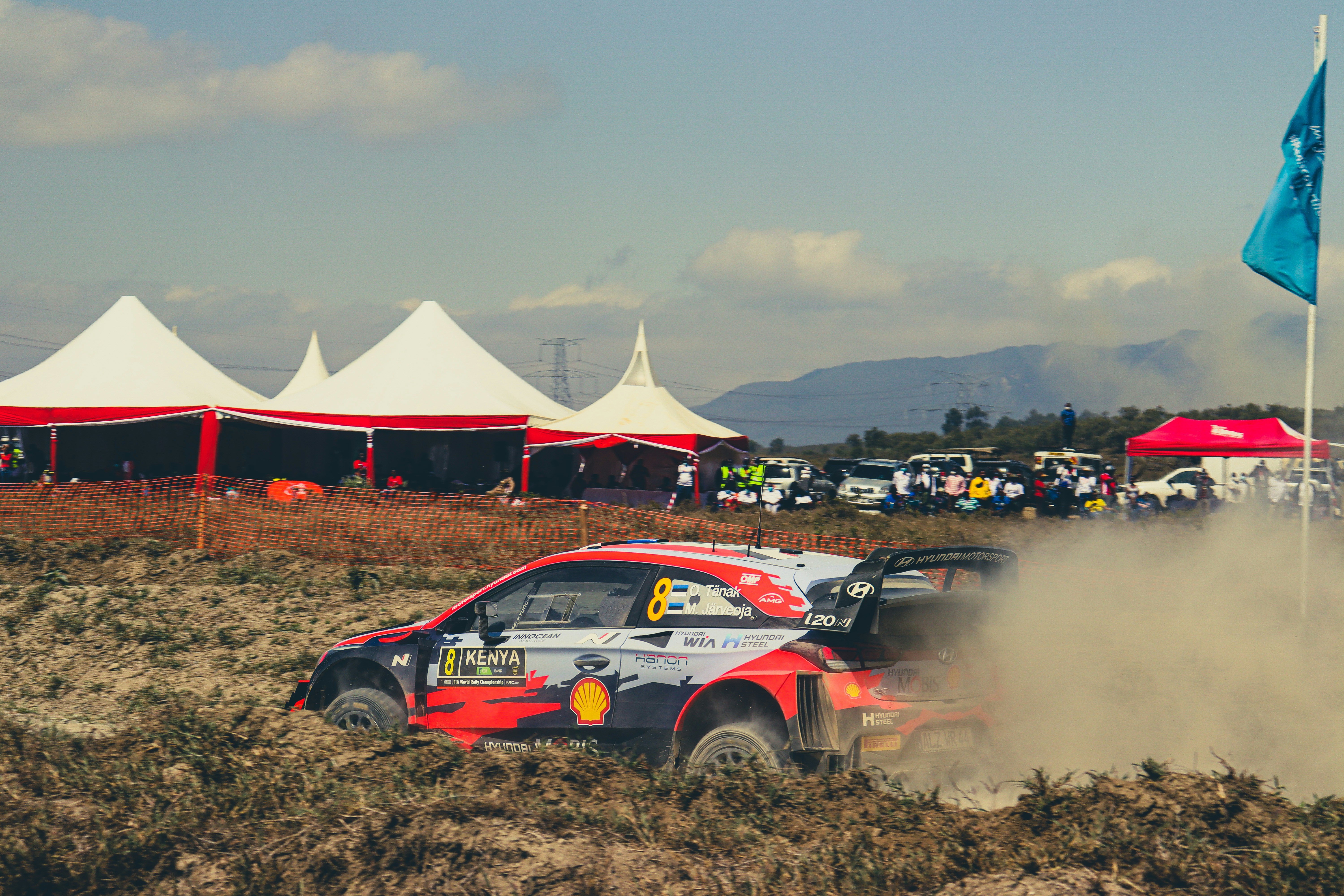 A rally car driving through a dirt field photo – Free Hell's gate Image ...