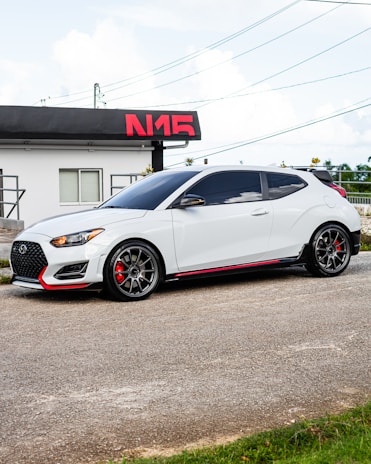 A clean, modern car from Naik Travels parked on a sunny street in Anantapur.