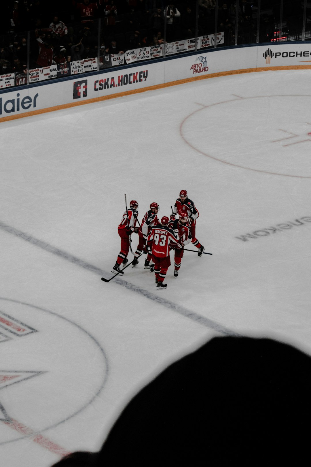 men in red ice hockey jersey playing hockey