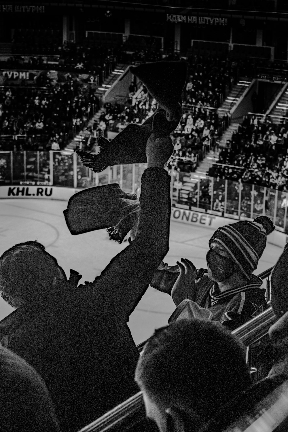 grayscale photo of people on ice skating rink