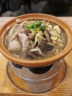 Freshly prepared sinigang na baboy bubbling in a traditional clay pot