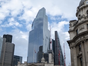 A city skyline featuring both contemporary skyscrapers and classic buildings, symbolizing real estate and growth.