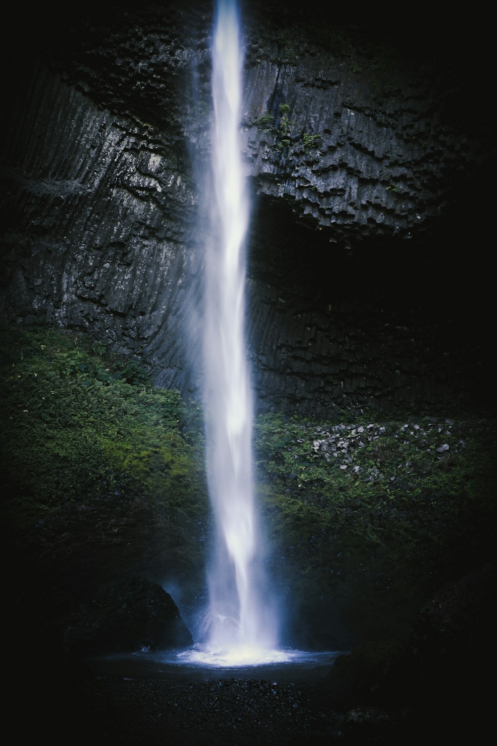 water falls in the middle of the forest