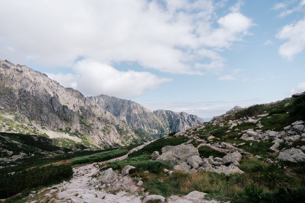 green and brown mountains under white clouds during daytime