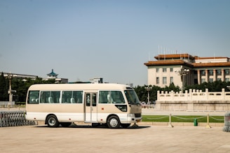 white van parked on gray concrete road during daytime