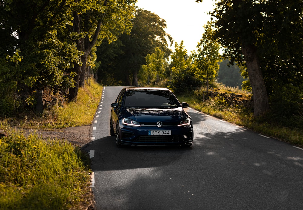 blue porsche 911 on road during daytime