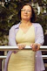 woman in white long sleeve shirt smiling
