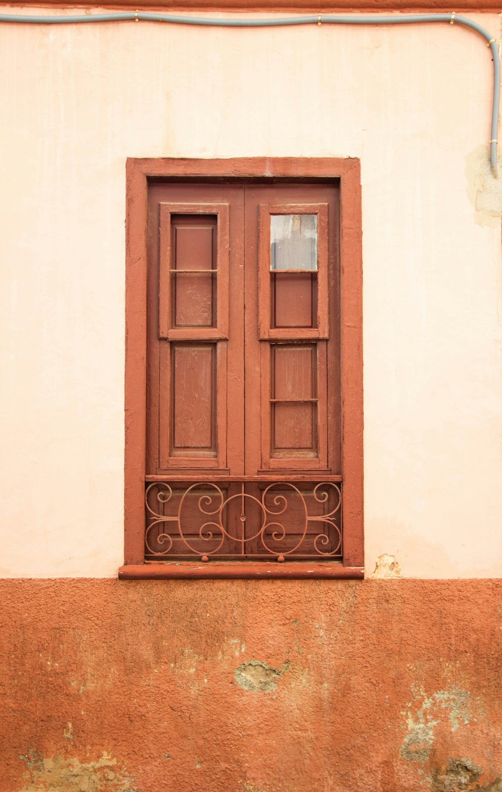 brown wooden door on white concrete wall