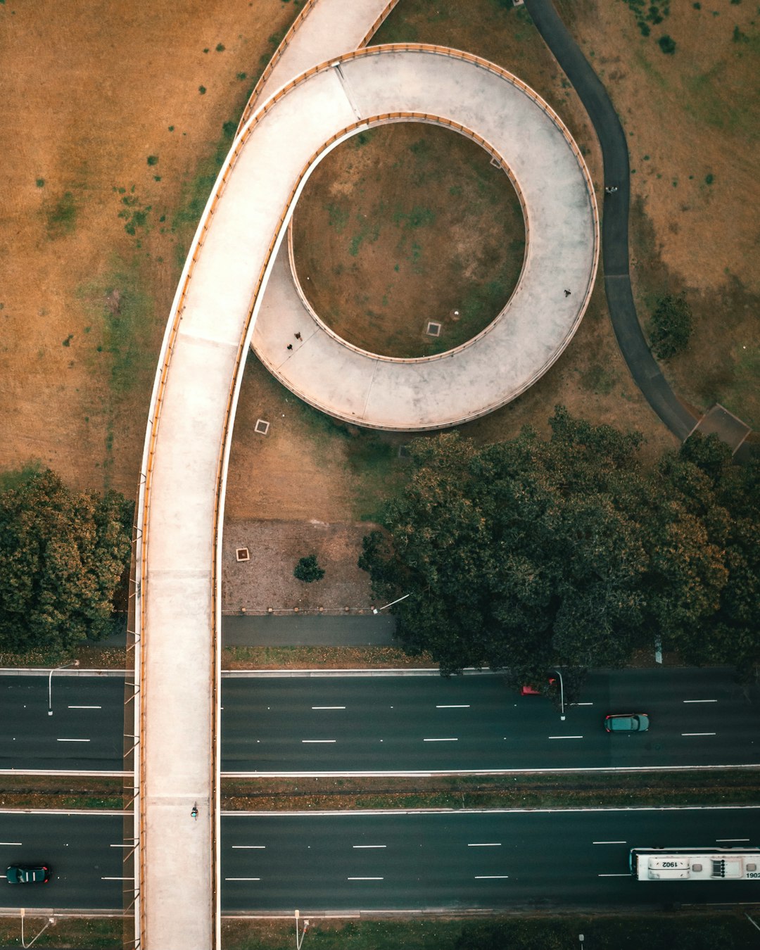 white and brown tunnel near green trees during daytime